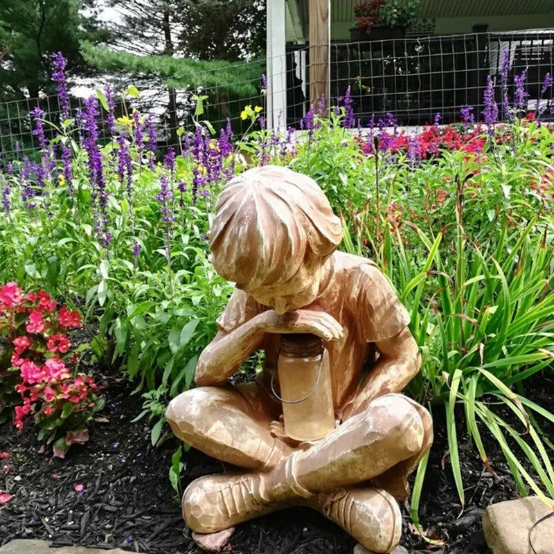 Boy with firefly light statue