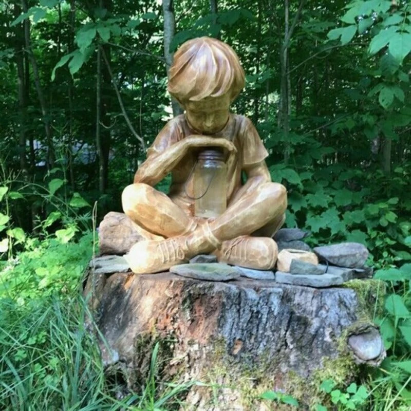 Boy with firefly light statue