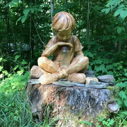 Boy with firefly light statue