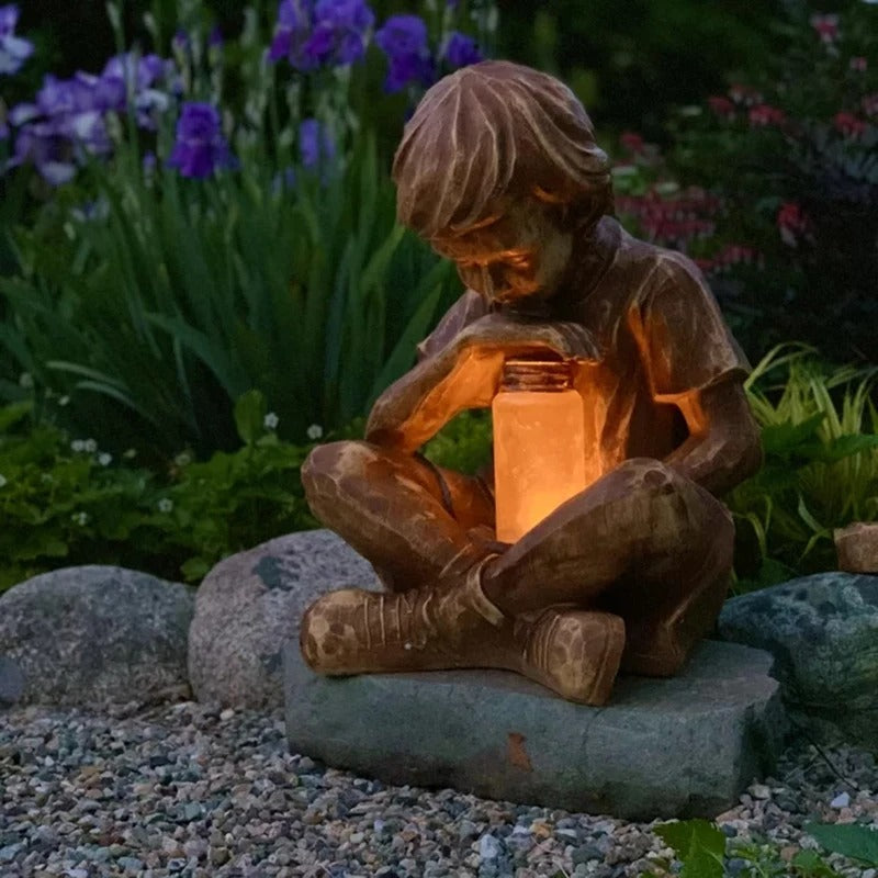 Boy with firefly light statue